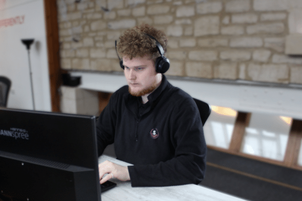 IT Technician at his desk on a call