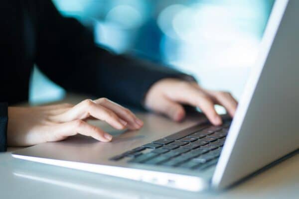 A photo of a user on a a laptop